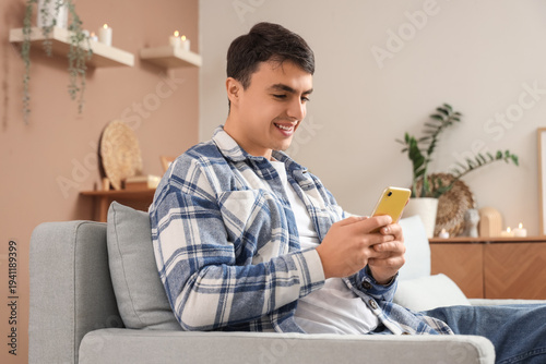 Young man having online dating at  home