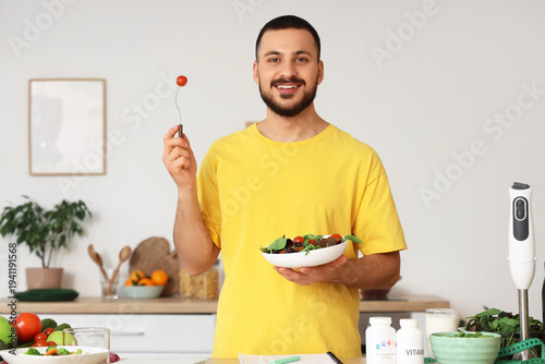 Handsome young man eating f...