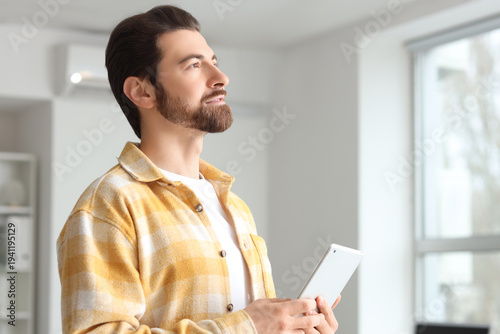 Handsome man with tablet co...