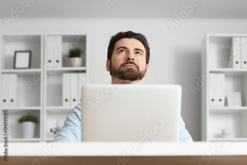 Young businessman looking u...