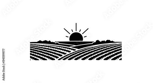 Picturesque agricultural landscape with sunrise over expansive cultivated fields and rolling hills