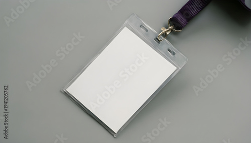 Blank identification badge holder with purple lanyard on a gray background