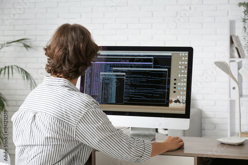 Male programmer working wit...