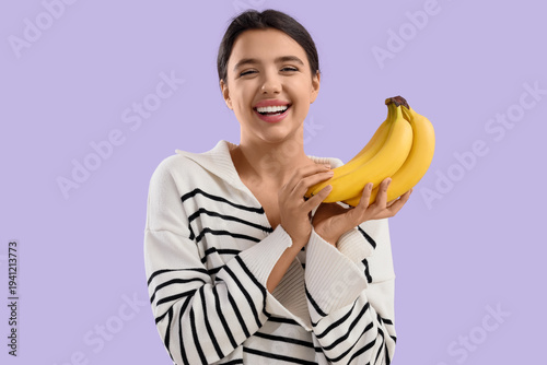 Young woman with bananas on...