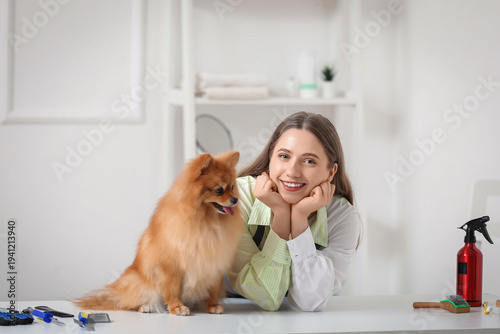 Female groomer with cute Po...