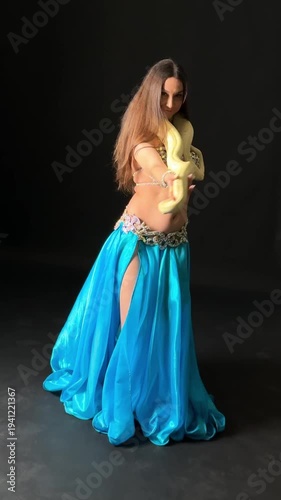 Exotic Belly Dancer Gracefully Interacting with Albino Python