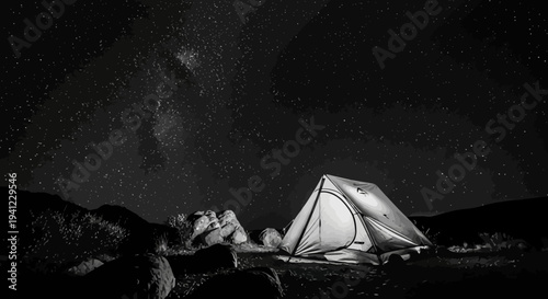Serene illuminated camping tent under a magnificent starry night sky in black and white, wilderness adventure