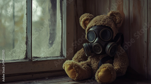 Teddy bear wearing gas mask by frosted window