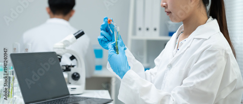 Scientist analyze biochemical samples in advanced scientific laboratory. Medical professional use dropper mix microbiological developmental of viral. Biotechnology research in  science lab. cosmetic