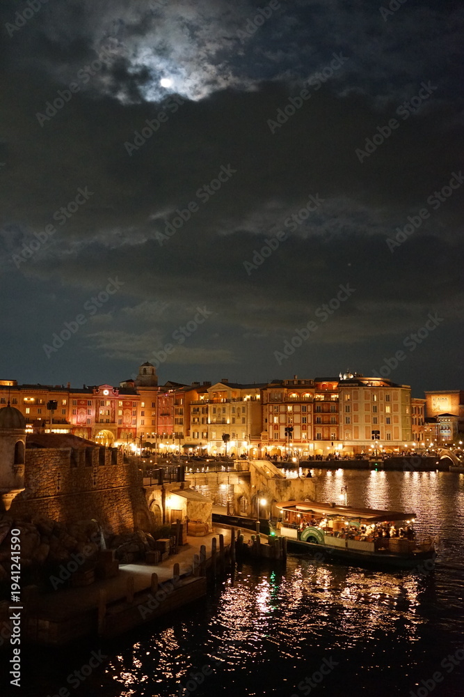 Fototapeta premium The photo captures a historic European harbor with boats gently docked along the water. The scenic view showcases charming architecture and peaceful waters, reflecting the rich maritime culture of the