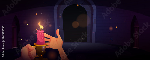 Hand holding candle in dark dungeon at night