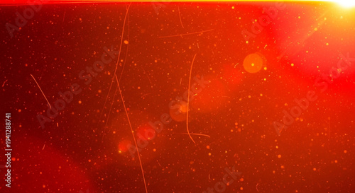 Vibrant red background with sparkling particles and lens flares creating a dynamic abstract design