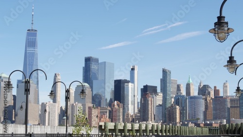 New York City Manhattan Downtown Financial District skyline, World Trade Center tower from New Jersey Liberty state park, United States. Pier lantern lamps and urban cityscape, skyscraper buildings.