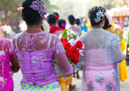 Women walking with offerings for a novitiation ceremony, Bagan,  Myanmar