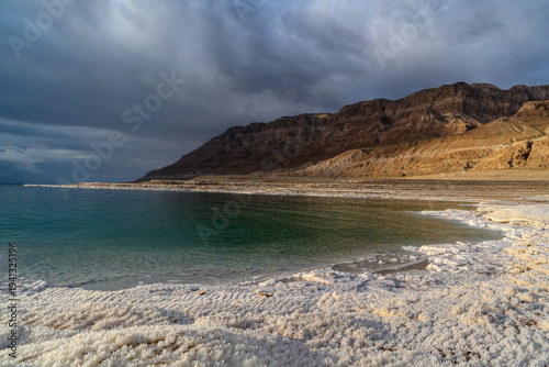 View of the Dead Sea at dawn, salt on the shore, Mount Masada, Israel