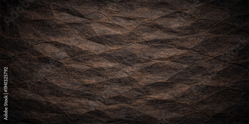 A dark grunge leather texture featuring a rough aged surface with vintage material patterns for a sophisticated wallpaper design