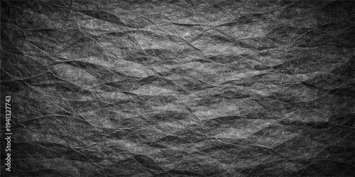 Dark crumpled black leather and rough fabric texture background with a vintage grunge paper material surface and seamless wrinkled pattern design