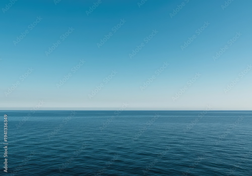 Obraz premium A vast, simple scene showing the meeting point of the calm, deep ocean and the clear, expansive blue sky, creating an ideal minimalist background, pure, expansive, quiet