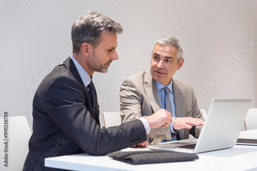 Two businessmen working together in office