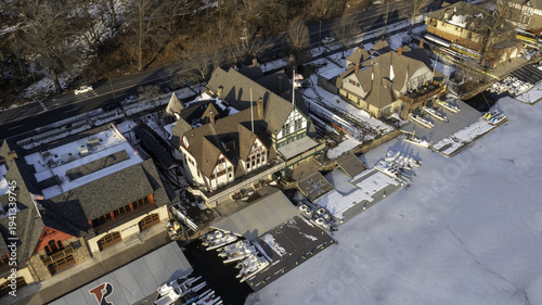 Aerial view of the historic Boathouse Row reflecting on the Schuylkill River's icy surface, contrasting with the vibrant architecture, Philadelphia, Pennsylvania, United States.