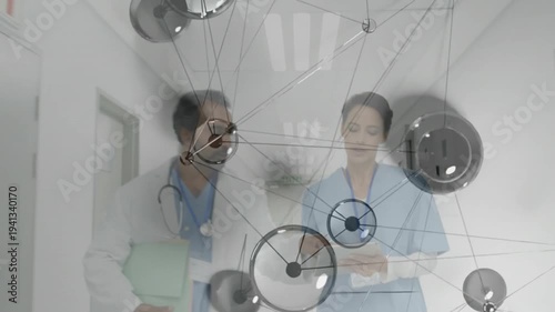 Med nurse and doctor reviewing clinical data while walking hall nodes moving over steth and tablet