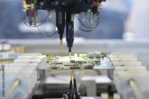 robot automatically assembles circuit board with electronic components in a modern factory