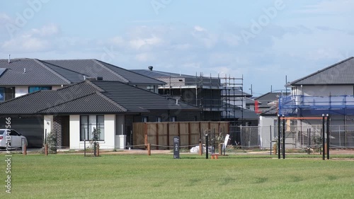 New suburban homes and houses under construction in Aintree, Melbourne, Australia. Modern residential development with scaffolding and newly built houses. Rapid expansion of outer suburban communities