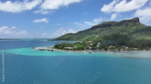 4k aerial video footage, flying round Ofu O Rau Point along Bora Bora Island coastline, French Polynesia, with Mount Otemanu, Mount Pahia and green hilly landscape in the background - 4k aerial video 