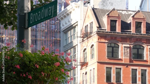New York City Broadway street sign on Manhattan, United States. Urban road sign in american city. Traffic sign in Midtown. Building architecture in Flatiron district. Crossroad with 5 fifth avenue.