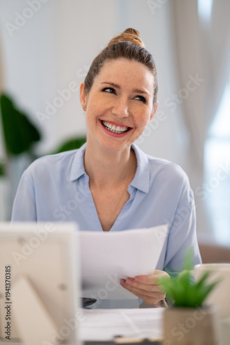 Young business woman looking busy while working from her home office