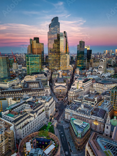 Photography Aerial view of the illuminated City of London, England, skyline with Bank and Co