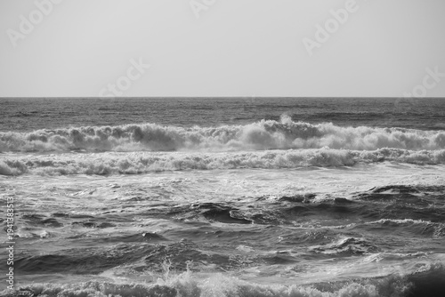 Seascape with crashing waves. Black and white ocean photography highlights the contrast between the foam and the water
