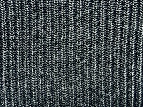 black white ribbed knit fabric macro closeup reveals intricate vertical zigzag yarn texture cozy monochrome pattern