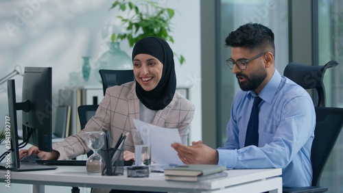 Photos Two business colleagues happy positive in office talking with computer working A