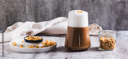 Canvas Print Gourmet peanut raf coffee in a glass on the table web banner