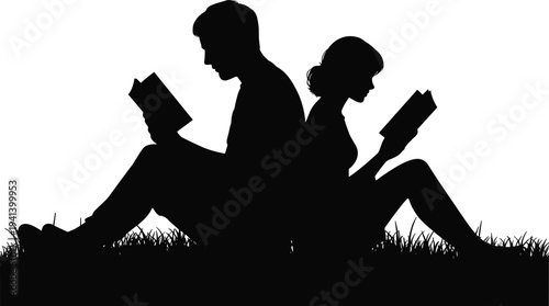 Silhouette of young man and woman sitting back to back on grass reading books outdoors in nature at sunset or evening