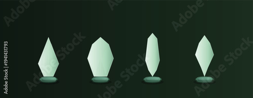 Describe four unique glass trophies or awards with a glowing green hue standing on a dark background