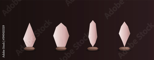 Four stylized light brown crystalline award trophies with unique geometric forms stand on dark circular bases