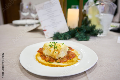 Cod cooked in sauce, served as a second course at a wedding. Andalusia, Spain