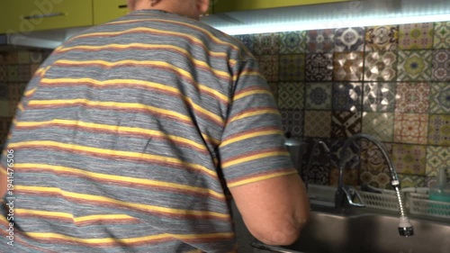 Elderly woman cooking food at kitchen. Grandmother at home