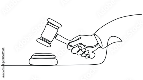 A hand holding a gavel next to a sound block