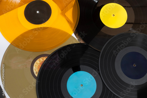 Vintage vinyl records of different sizes and colors on table