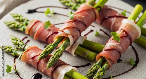 Fresh green asparagus spears wrapped in prosciutto ham served with balsamic glaze. Gourmet appetizer snack for healthy dinner. Mediterranean food cuisine, culinary vegetable dish concept.