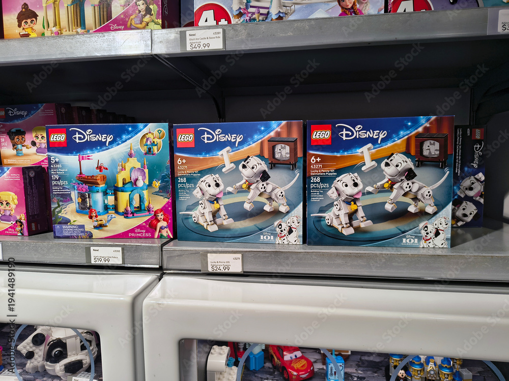 Obraz premium LEGO Disney toy sets display on store shelf including 101 Dalmatians, Little Mermaid and Cars