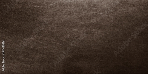 Vintage dark brown leather texture background with a rough grunge pattern on an old weathered material surface for a dark rustic wallpaper backdrop design