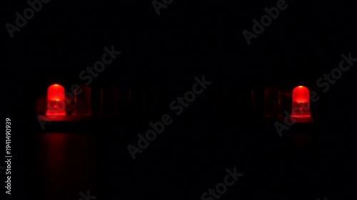 Row of red LEDs with running light animation in darkness.