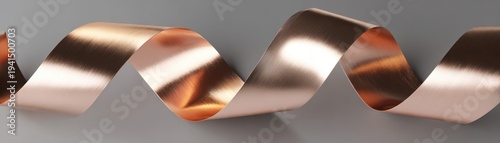 Wavy strip of brushed rose gold or copper metal material flowing across  gray surface