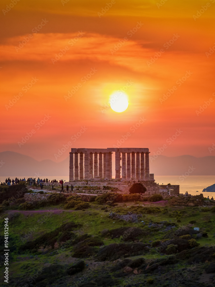 Fototapeta premium Sunset view of the ancient Temple of Poseidon at Cape Sounion at the edge of Attica, Athens, Greece