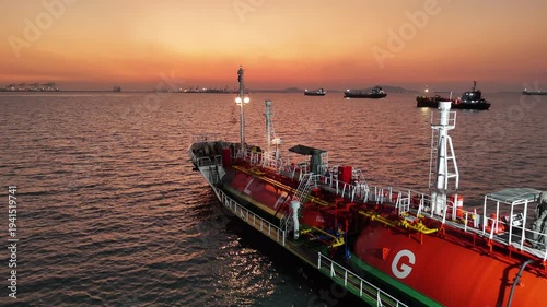 4K LPG tanker ship floating on sea surface during golden sunset