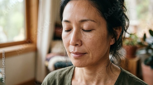 Close-up of a person's face during meditation, focus on skin texture and serenity, natural light, no retouching look.